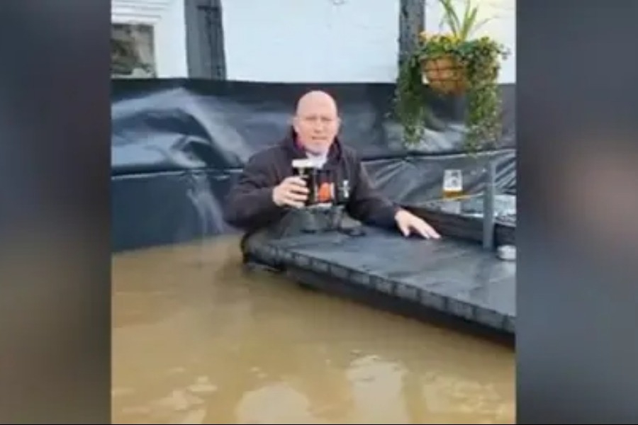 Επικός τύπος απολαμβάνει την μπύρα του έξω από το πλημμυρισμένο του μαγαζί